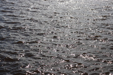 Blue water texture. Ocean and ripples on the water on a sunny summer day.