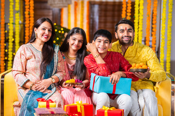 Indian family with kids celebrating rakhi or rakshabandhan festival or diwali