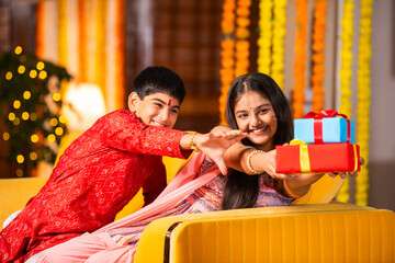 Indian brother and sister enjoying togetherness while celebrating rakhi, rakshabandhan or bhai dooj