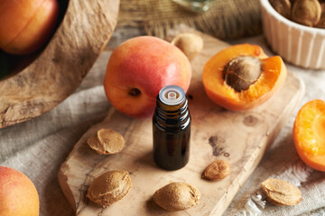 Apricot kernel oil in a glass bottle with fresh apricots
