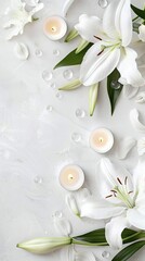 Two clear glass candle holders, each containing a lit white candle, rest amongst white lilies and green leaves