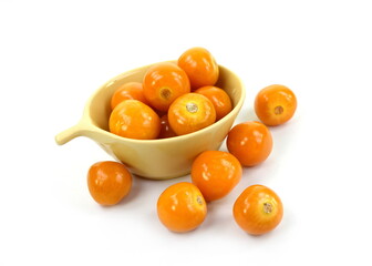 Uchuva (golden berry) delicious fruit isolated on white. Cape gooseberries in a wooden bowl. Fresh fruits of Physalis peruviana, also known as golden, inca and ground berry, uchuva, poha
