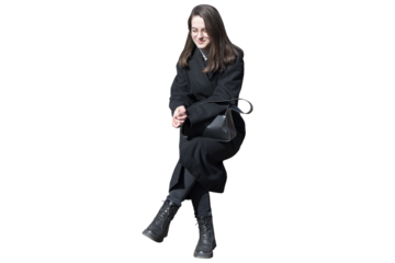 A woman in black coat in sitting pose isolated
