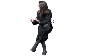 A woman in black coat in sitting pose isolated