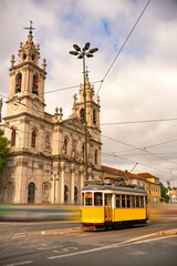 Basilica da Estrela and typical yellow tram in Lisbon, Portugal 