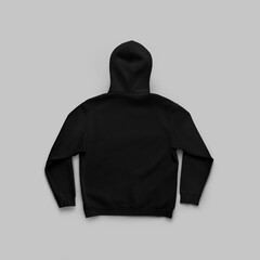 Mockup of an oversized black hoodie, back view, unfolded on a white background with shadows.