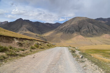 Long and winding dirt roads going through the countryside and mountains of Kyrgyzstan