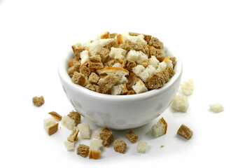 Bread croutons on a white background. Scattered pile of homemade rye bread croutons isolated on white background. Crispy bread cubes, dry rye crumbs, rusks, crouoton or brown roasted crackers