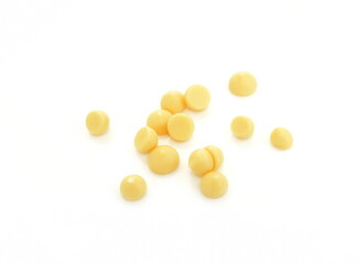 Organic cocoa butter buttons (wafers) isolated on white background