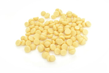 Organic cocoa butter buttons (wafers) isolated on white background