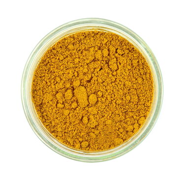 curry powder in a flass bowl isolated on white background