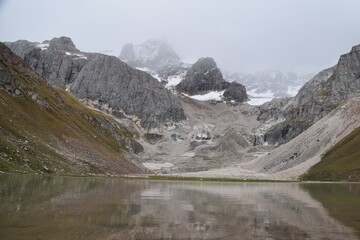Beautfiul mountain reflections in a glacial lake in Kyrgyzstan, Central Asia