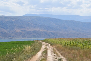 Long and winding dirt roads going through the countryside and mountains of Kyrgyzstan