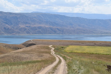 Long and winding dirt roads going through the countryside and mountains of Kyrgyzstan