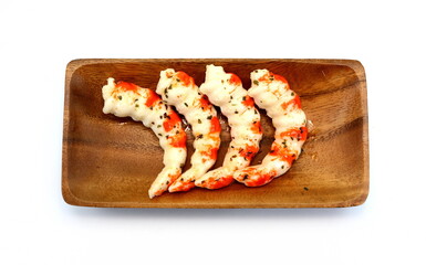 Cooked shrimps in a wooden bowl isolated on white background.