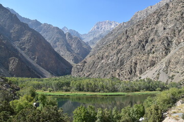 The stunning turquoise lake Iskanderkul and surrounding mountains and valleys in Tajikistan, Central Asia