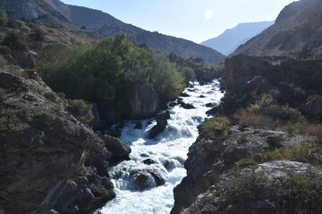 The stunning turquoise lake Iskanderkul and surrounding mountains and valleys in Tajikistan,...