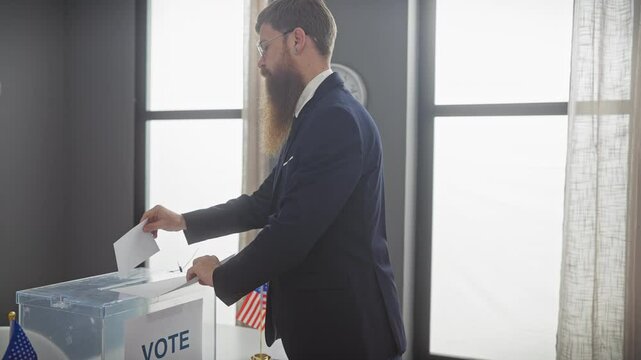 A bearded man in a suit drops a ballot into a voting box, american flags in the background, symbolizing democracy and election.