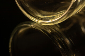 The photograph shows the details of the beautifully curved glass against a black background.