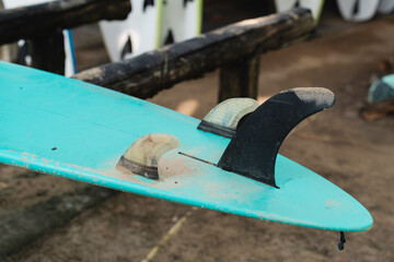 Close-Up of Surfboard Fins with Sand in Authentic Surf Camp