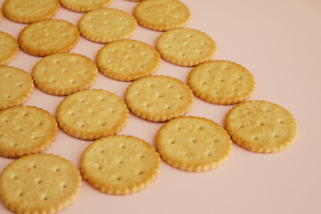 Salty crackers on a pink background close-up, cookies on the table