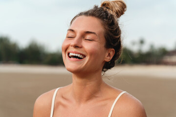 Close-Up of a Laughing Woman on the Beach