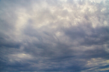 Gray-blue skies and gloomy clouds block out the sunlight, dramatic skies in dark colors