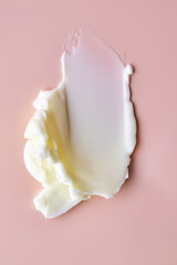 Texture of cosmetic butter on a pink background. Showcasing a thick and nourishing texture.