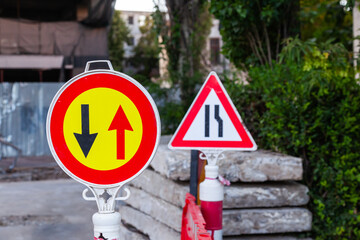 Warning signs and plastic fences at a construction site.