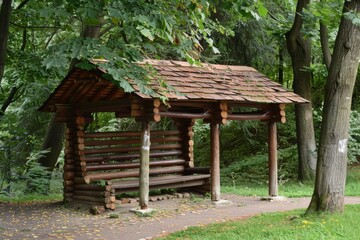 Wooden hut with bench in park