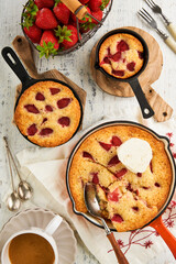 Strawberries chip skillet cookie or giant strawberries and cream frying pan cookie on rustic wooden table background. Traditional British or English dessert recipe. Top view. Place for text. Cover.