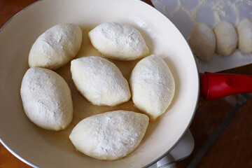 process of baking pies from yeast dough in a frying pan
