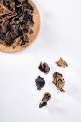 Close up of wild dried black fungus on white background