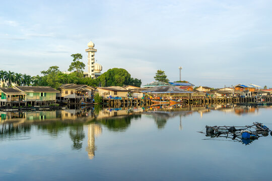 Local fishing village along the Bang Nara River with kolae boats colorful with a mosque in the background in the evening.