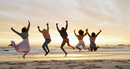 Fototapeta premium People, friends and jump on beach for freedom, outdoor adventure and group happiness on summer vacation. Carefree, back and youth energy with seaside fun, excited and sunset on holiday for weekend.