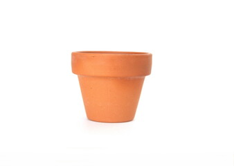 Classic tiny terracotta flowerpot on white background