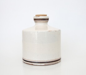 White vintage ceramic jar with cork on white background