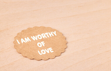 I am worthy of love, motivational text message on craft paper and wooden background,...