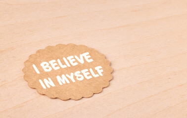 I believe in myself, motivational text message on craft paper and wooden background,...