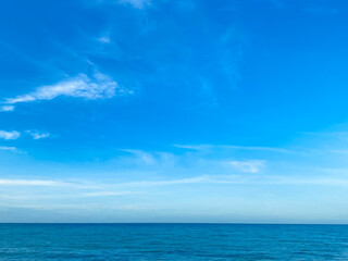 Nature view clear blue sky with Cirrus clouds background and soft oceans waves with a deep blue color on the sea