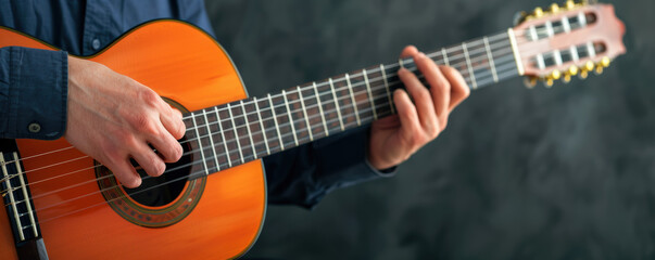 Obraz premium A musicians fingers strumming a guitar, capturing passion and dedication to their craft, dimly lit stage