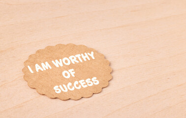 I am worthy of success, motivational text message on craft paper and wooden background,...