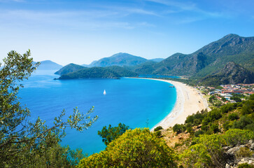 Aerial view of Ölüdeniz Beach, Turkey. Turquoise waters, sandy shoreline and lush green...