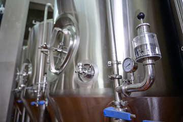 A small industry brewery's brewing tanks in a brewery that produces craft beer