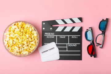 Tasty popcorn in buckets and cold cola drinks with cinema tickets, movie clapper and 3D eyeglasses...