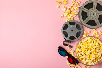 Tasty popcorn in buckets and cold cola drinks with cinema tickets, movie clapper and 3D eyeglasses...