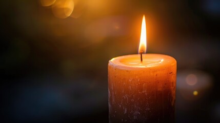 Captivating candle flame casting a soft glow on a somber dark background, creating a sense of warmth and solace