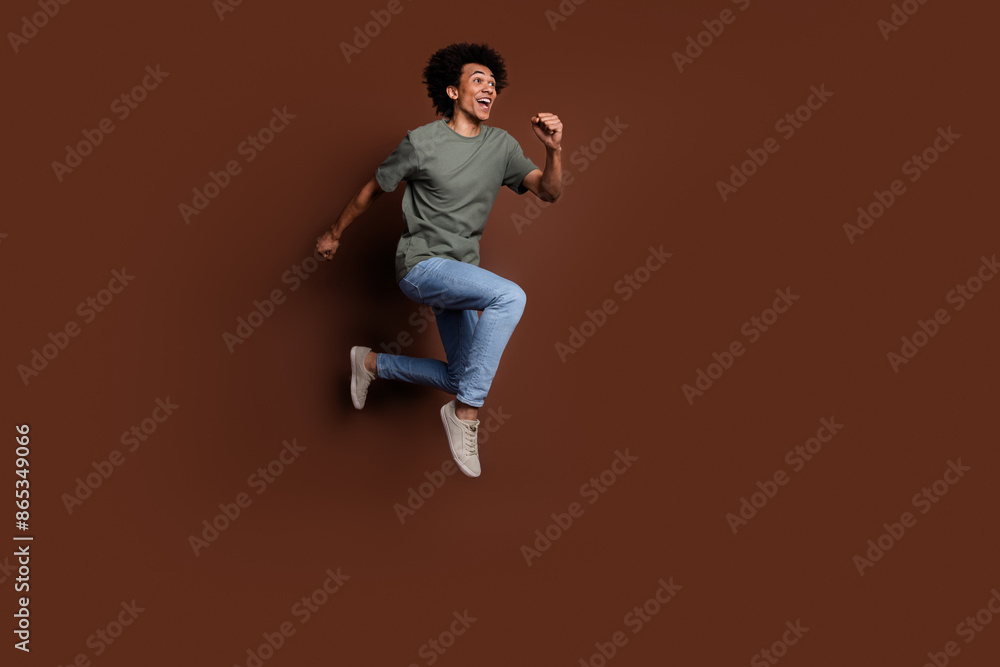 Canvas Prints Full body photo of attractive young man running have fun dressed stylish khaki clothes isolated on brown color background