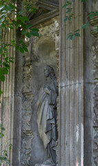 Close-up of an old half-faceless woman praying statue