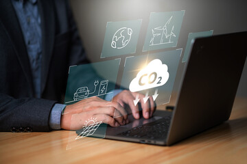 reduce CO2 emission concept , businessman using laptop surrounded by zero emissions icon ,...